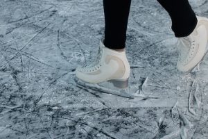 white ice skates gliding on ice